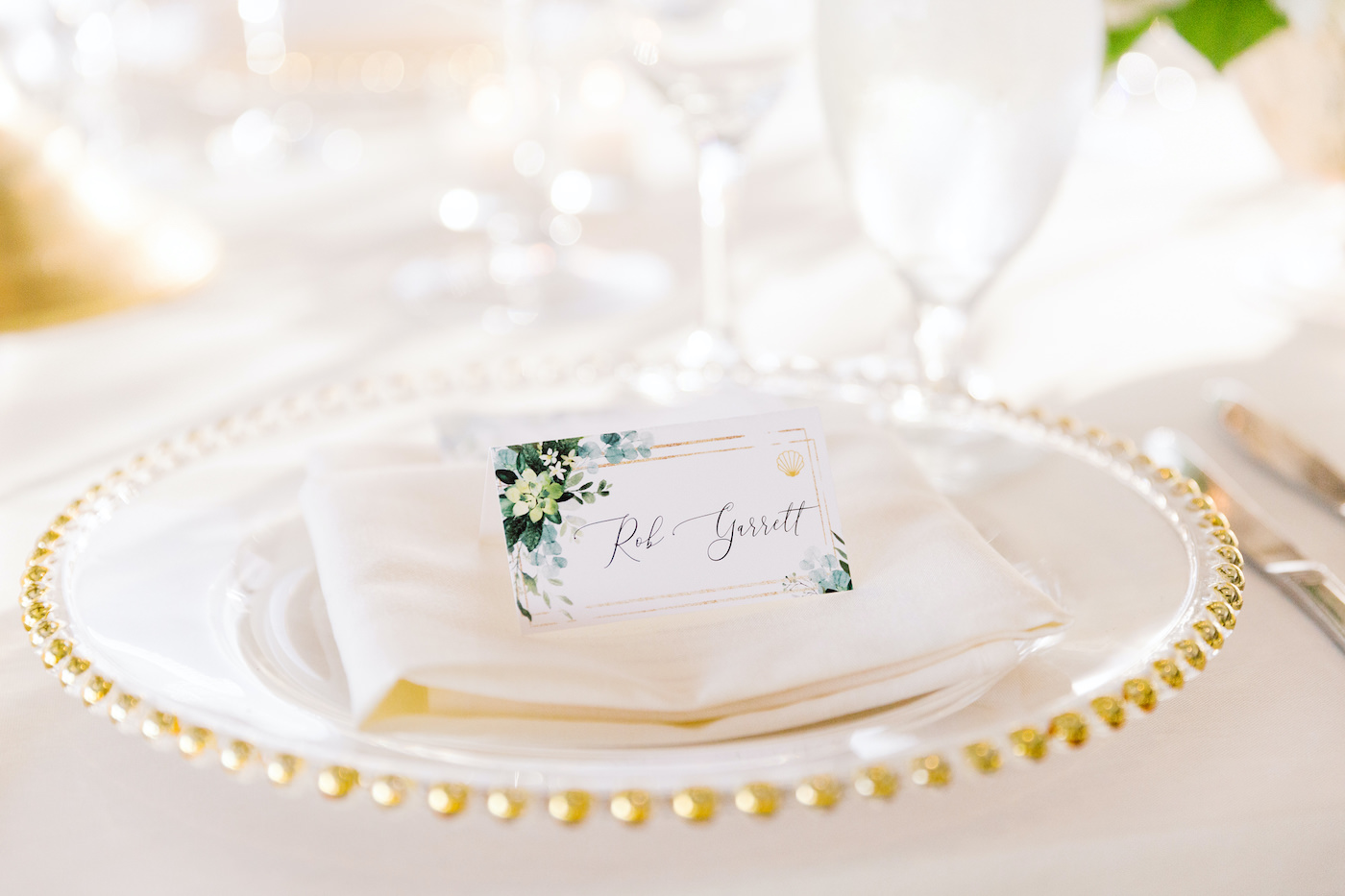 Elegant Wedding Reception Decor, Clear and Gold Beaded Charger with White Linen Napkin and Floral Seating Card | Tampa Bay Wedding Charger Rental Gabro Event Services