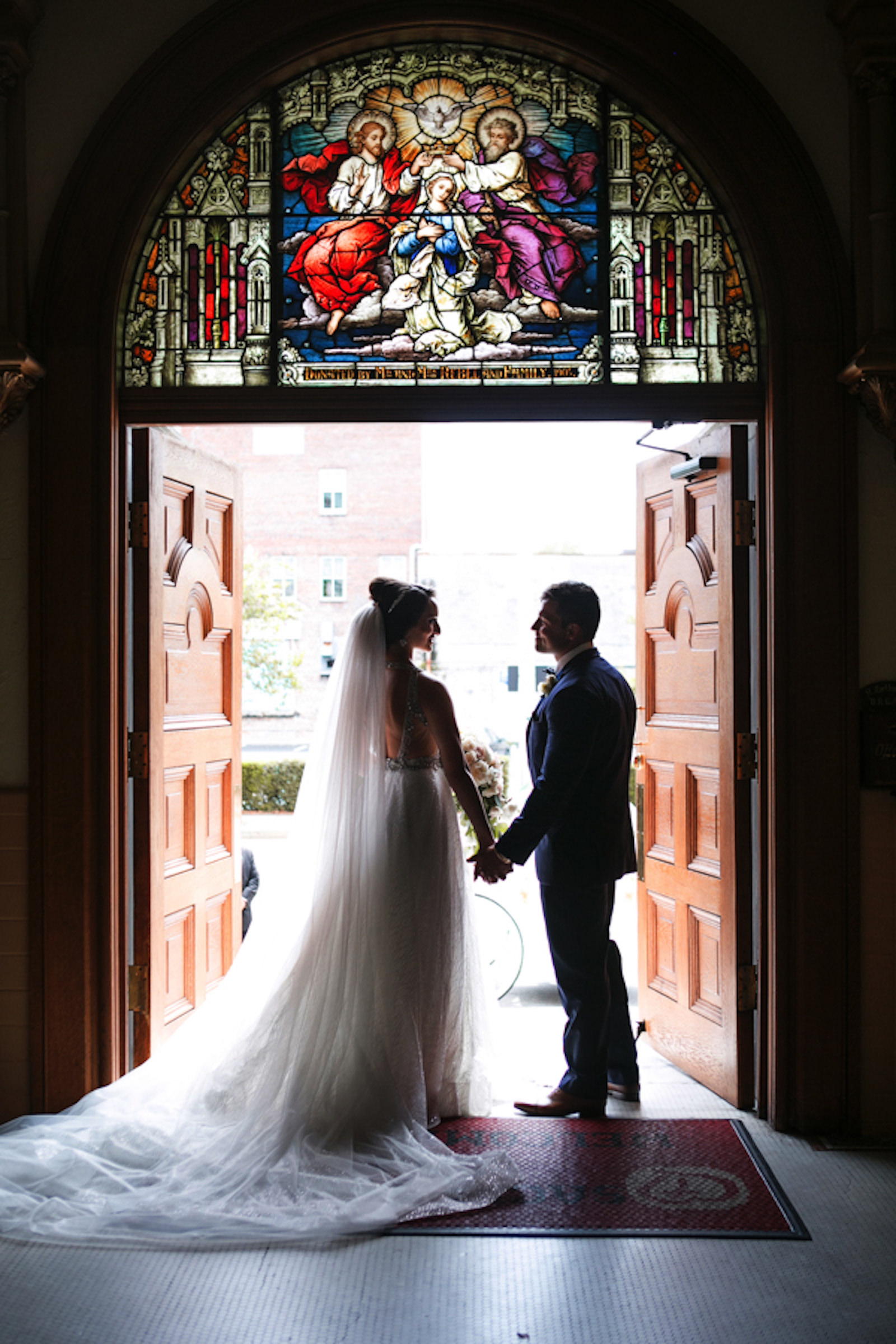 Indoor Downtown Tampa Bride and Groom Portrait at Traditional Catholic Ceremony Cathedral Church | V Neck Illusion Lace A Line Ballgown Wedding Dress with Rhinestone Waist Band and Cathedral Veil
