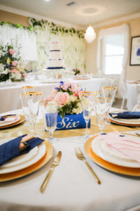 St. Petersburg Romantic, Modern Florida Wedding Reception and Decor at Private Residence, Gold Chargers, Dark Blue Linens, Cascading Flower Wall, Low Floral Centerpieces with Vibrant Pink, Purple, White and Ivory Flowers | Tampa Wedding Photographer Lifelong Photography Studio | Tampa Bay Wedding Caterer Catering by the Family | Furniture Event Rentals By Kate Ryan Event Rentals | Floral Decor Monarch Events & Design