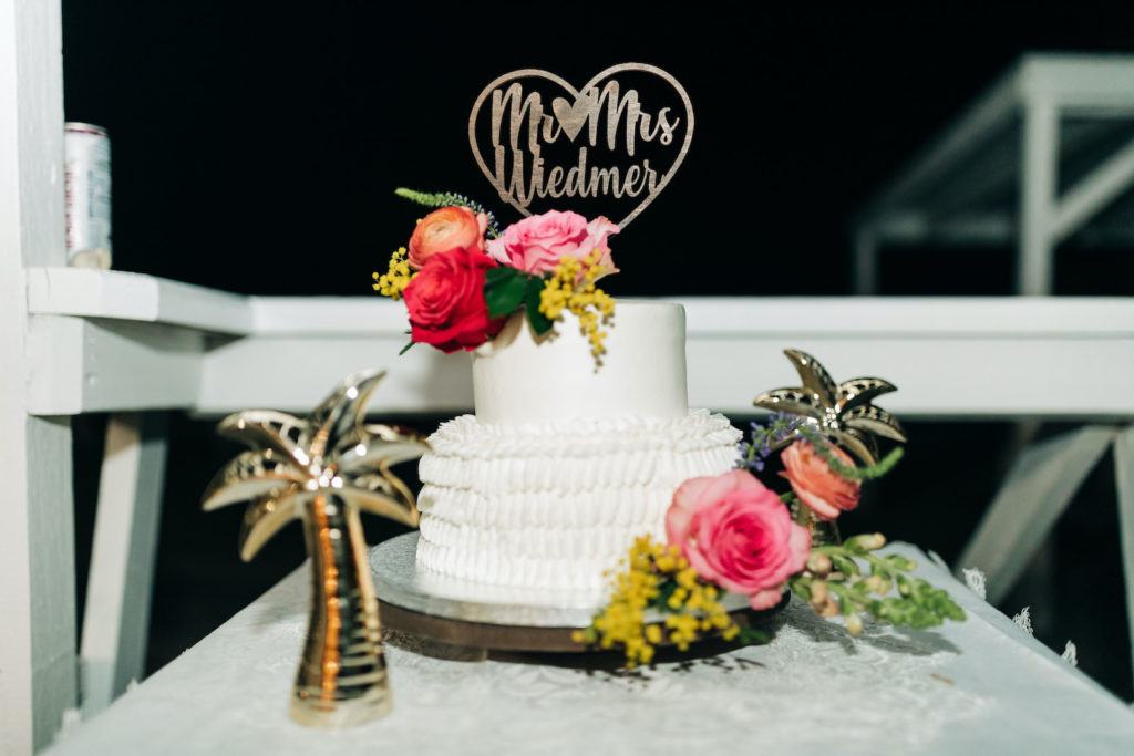 Outdoor St. Pete Tampa Florida Boho Elopement Two Tier Publix Wedding Cake with Buttercream Icing and Fresh Roses topped with Die Cut Gold Last Name Heart Topper
