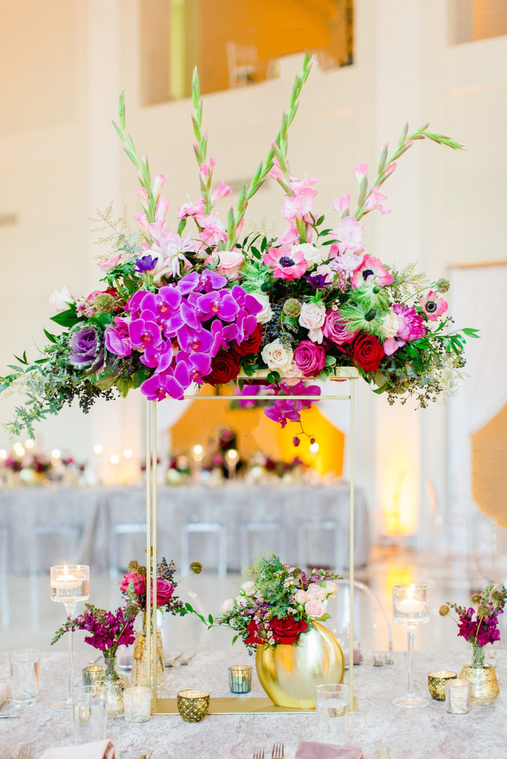 Colorful Luxury Tampa Wedding Centerpieces of Pink Gladiolas, Roses, Anemones, Orchids and Greenery with Gold Bud Vases and Candles
