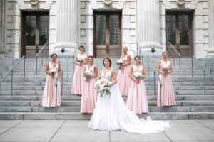 Outdoor Downtown Tampa Bride and Bridesmaids Portrait at Traditional Catholic Ceremony Cathedral Church Staircase | V Neck Illusion Lace A Line Ballgown Wedding Dress with Rhinestone Waist Band and Cathedral Veil | Blush Pink and Ivory Roses and Peonies Bridal Bouquets with Eucalyptus Greenery | Blush Pink Long Formal Silk Satin Bridesmaid Dresses