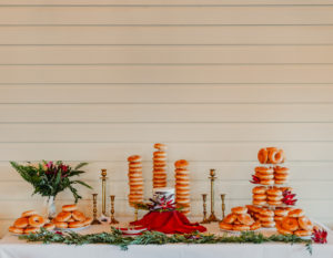 Wedding Dessert Table Donuts Display with Donut Towers from Krispy Kreme | Petite Small Wedding Cake Table with Greenery and Burgundy Red Protea
