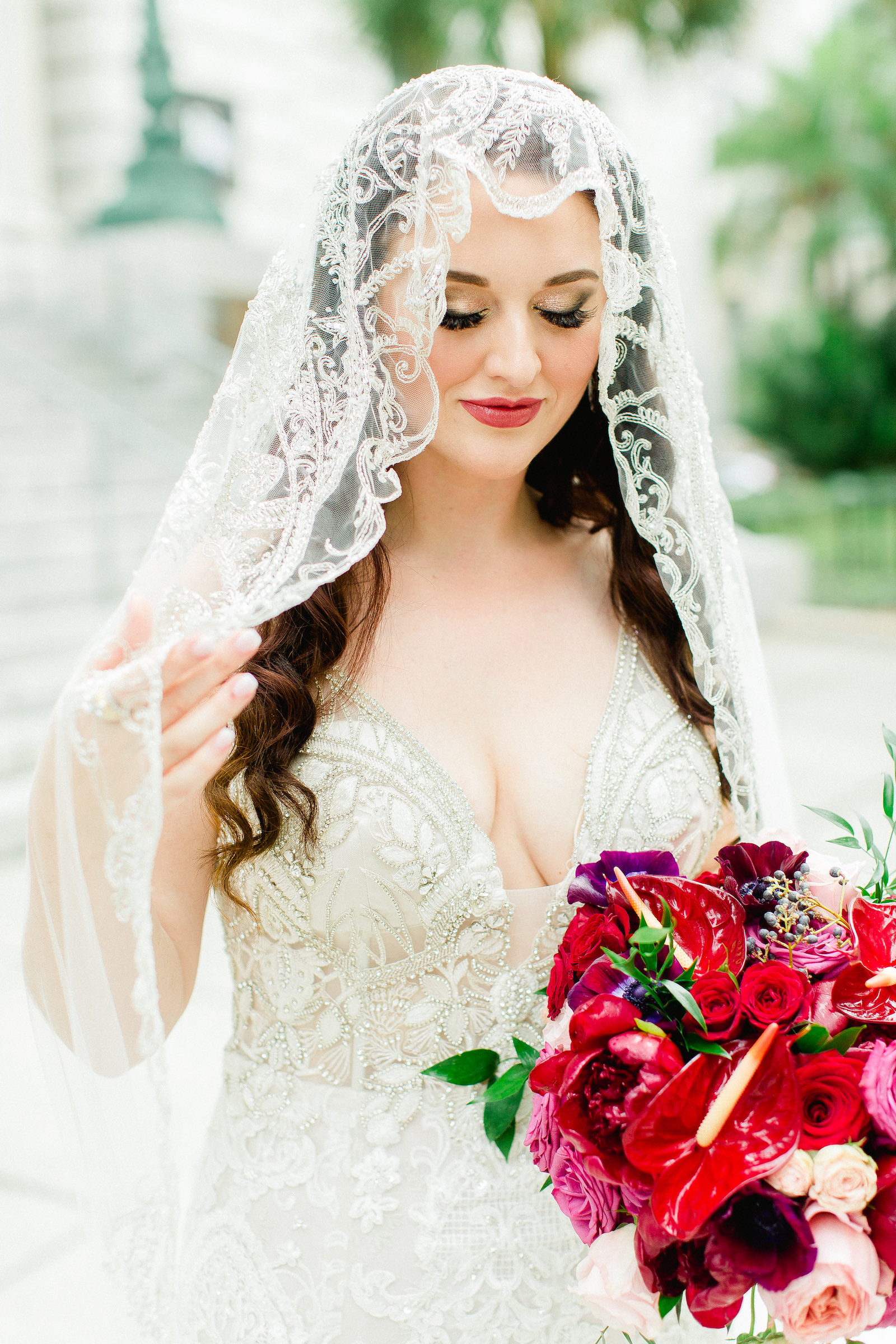 Bride Wearing Embroidered Rhinestone Circle Veil | Rhinestone Embroidered Wedding Dress Bridal Gown | Bright Colorful Pink and Red Wedding Bridal Bouquet with Roses and Flamingo Lilies Anthurium
