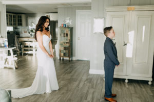 Bride and Step Son First Look | Spaghetti Strap Casablanca Ivory Simple Slip Wedding Dress Bridal Gown | Navy Blue Boys Wedding Suit