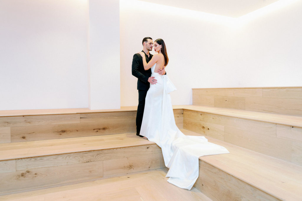 Bride and Groom Portrait | Modern Clean Indoor Wedding Space at Tampa Wedding Venue Hyde House | Dramatic Modern Ines di Santo Wedding Dress by Isabel Oneil Bridal | Groom in All Black Suit
