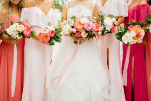 Tropical Vibrant Bride and Bridesmaids in Pink and Coral Dresses Holding Colorful Pink and White Roses Floral Bouquets