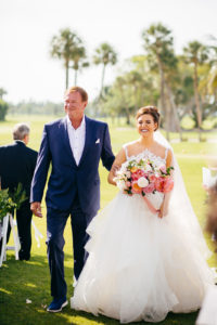 Tropical Bride in Lace and Illusion High Neckline Tulle Skirt Ballgown Wedding Dress Holding Colorful Floral Bouquet