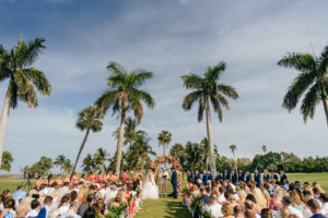 Tropical Wedding Ceremony Decor, Colorful Pink and Coral Floral Arch, Bride and Groom Exchanging Vows | Boca Grande Wedding Venue Gasparilla Inn | Tampa Bay Wedding Planner NK Weddings