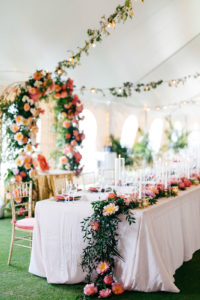 Elegant Tropical Tent Wedding Reception Decor, Pink and Coral with Greenery Floral Table Runner, Gold Chiavari Chairs with Pink Cushions | Tampa Bay Wedding Planner NK Weddings