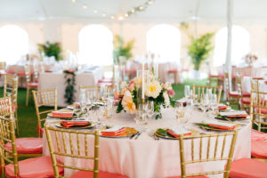 Elegant Tropical Tent Wedding Reception Decor, Round Table with Gold Chargers, Pink Linen Napkin, Colorful Low Floral Centerpieces, Gold Chiavari Chairs with Coral Cushions | Tampa Bay Wedding Planner NK Weddings