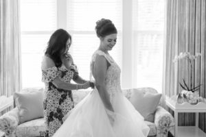 Tampa Bride Getting Ready Photo Putting on Sottero and Midgely Lace and Illusion Bodice and Tulle Skirt Ballgown Wedding Dress