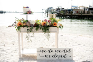 Intimate Florida Vow Exchange and Elopement Decor, Vibrant Florals with Yellow Sunflowers, White Florals, Orange, Pink and Purple Flowers, Small One Tier Top of Cake with Floral Embellishments | St. Petersburg Private Beachfront Wedding Venue Isla Del Sol | Florida Elopement Planner Elope Tampa Bay