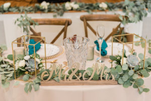 Wedding Bride and Groom Sweetheart Table with Mr and Mrs Sign and Gold Lantern Centerpieces with Succulents and Eucalyptus Greenery