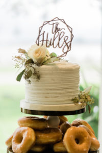 South Tampa Brunch Wedding Donut Tower Display topped with One Small Single Tier Buttercream Wedding Cake with Gold Geometric Name Topper and Eucalyptus Greenery by Alessi Bakery