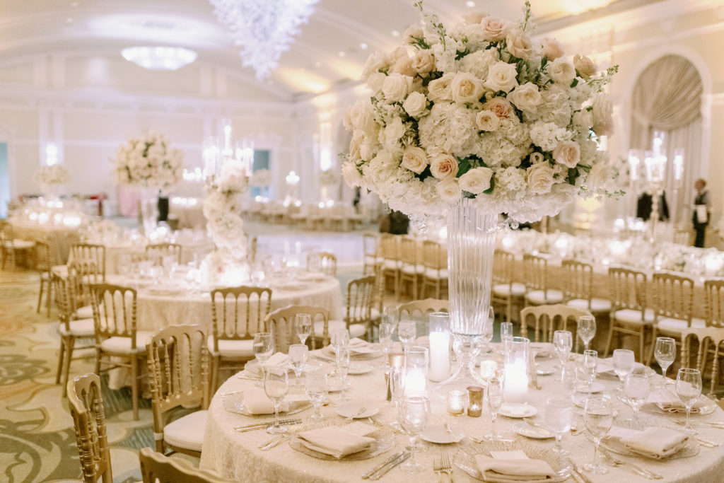 Elegant Florida Wedding Reception Decor, Round Tables with Tall Floral Centerpieces, Romantic Garden-Inspired Decorations with Luxurious White Hydrangeas and Snapdragons Flowers, Blush Pink Roses, and Candles in Mercury Glass Votives, Champagne Table Linens, Modern Gold Napoleon Chairs | Tampa Bay Wedding Planner Parties A La Carte | Downtown St. Petersburg Wedding Venue and Historic Resort The Renaissance Vinoy, The Grand Ballroom