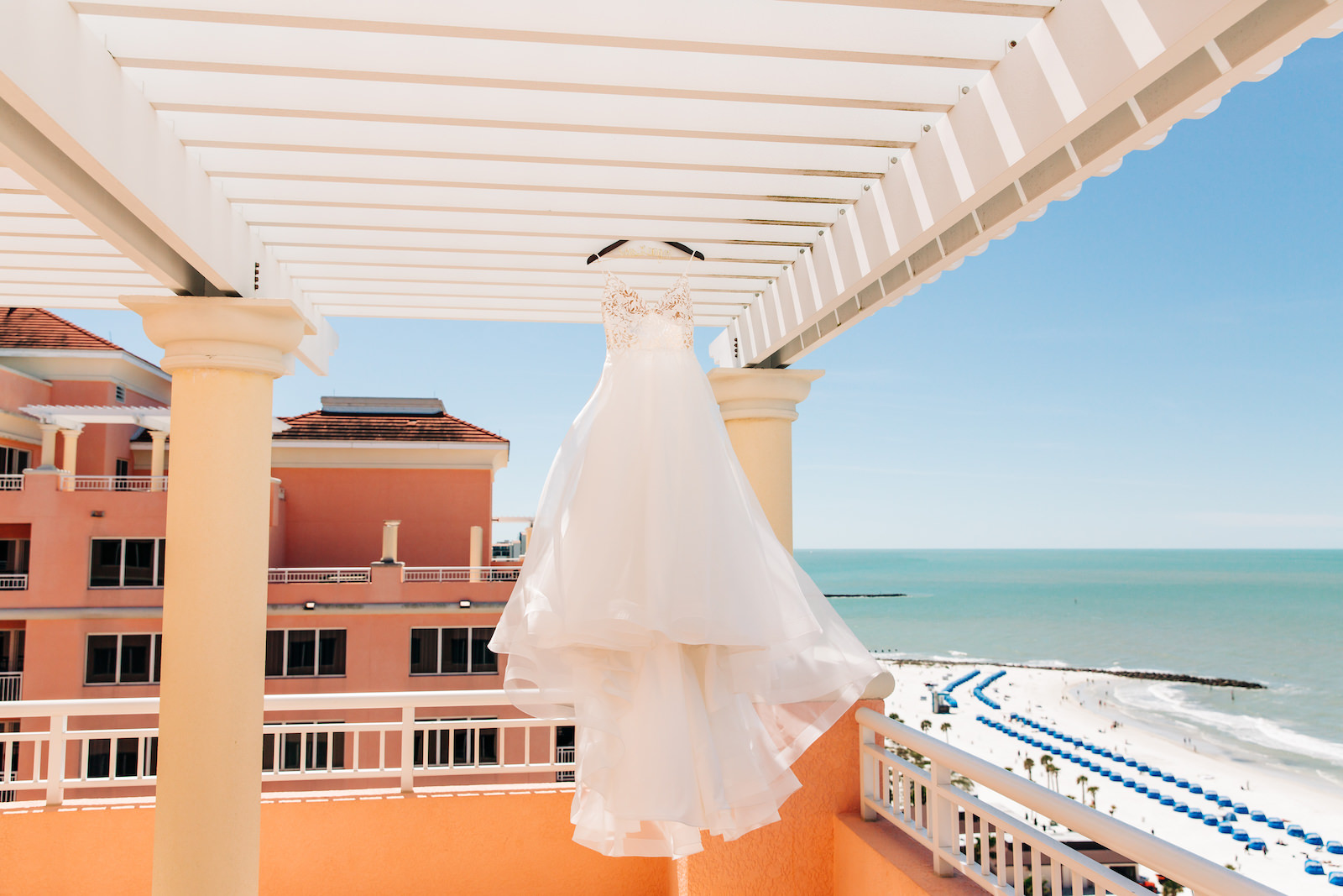 Florida Beachfront Wedding Venue with Hanging Mikaella Bridal Dress Full Tulle Skirt and Floral Lace Appliqué Bodice | Hyatt Regency Clearwater Beach