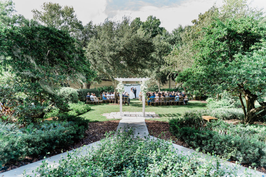 Outdoor Ceremony with Cross Back Wood Chairs at Tampa Wedding Venue Tampa Garden Club