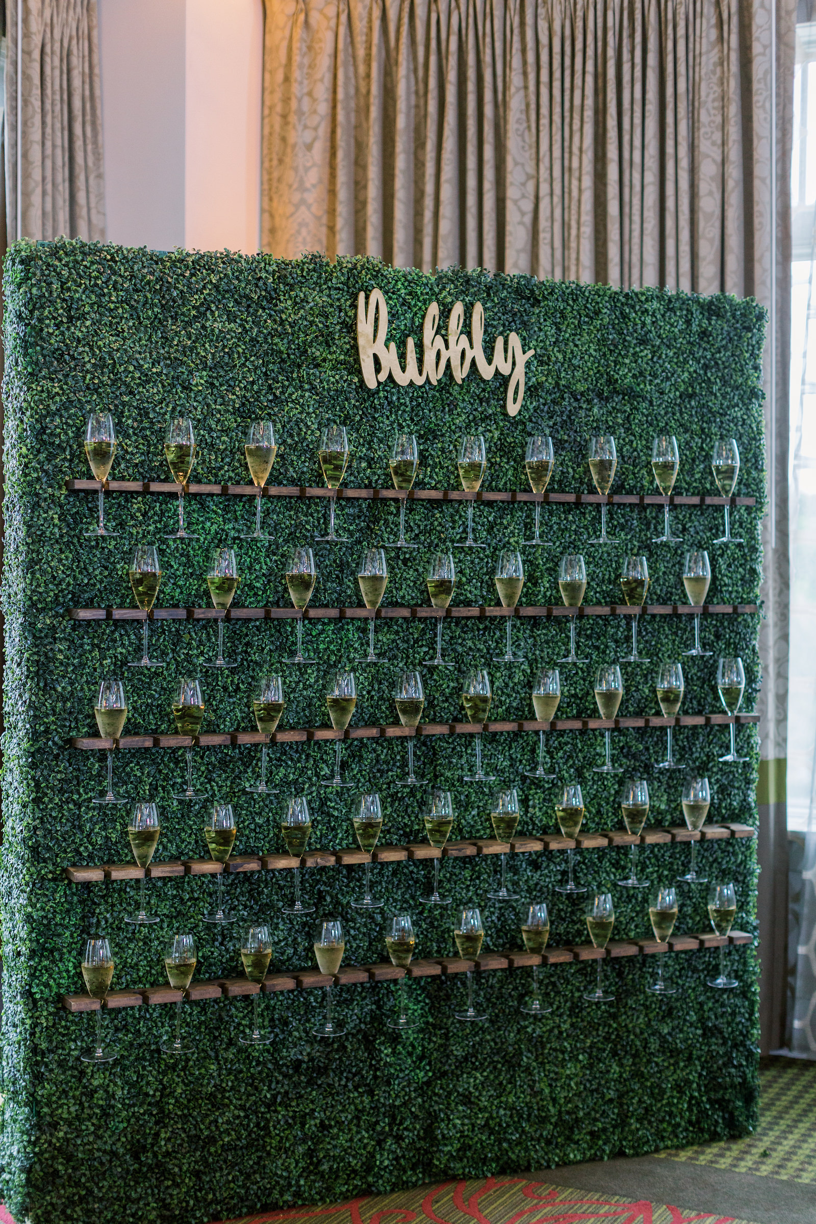 Wedding Champagne Wall Greenery Boxwood Hedge with Glasses of Bubbly by
