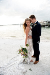 Florida Bride and Groom During Intimate Vow Exchange During Beachfront Ceremony under Gazebo, Bride Wearing Made With Love Bridal Tan Sasha Dress, Holding Whimsical Vibrant Inspired Bouquet | Private Tampa Bay Wedding Venue Isla Del Sol Yacht and Country Club | Intimate Wedding Planner Elope Tampa Bay