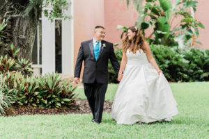 Outdoor Bride and Groom Portrait at Tampa Garden Club Wedding Venue | Ivory Private Collection Simple Classic Sweetheart Neckline Strapless A Line Wedding Dress Bridal Gown with Pockets by Truly Forever Bridal Tampa | Groom in Classic Black Tuxedo Tux Suit with Aqua Teal Turquoise Blue Tie and Vest
