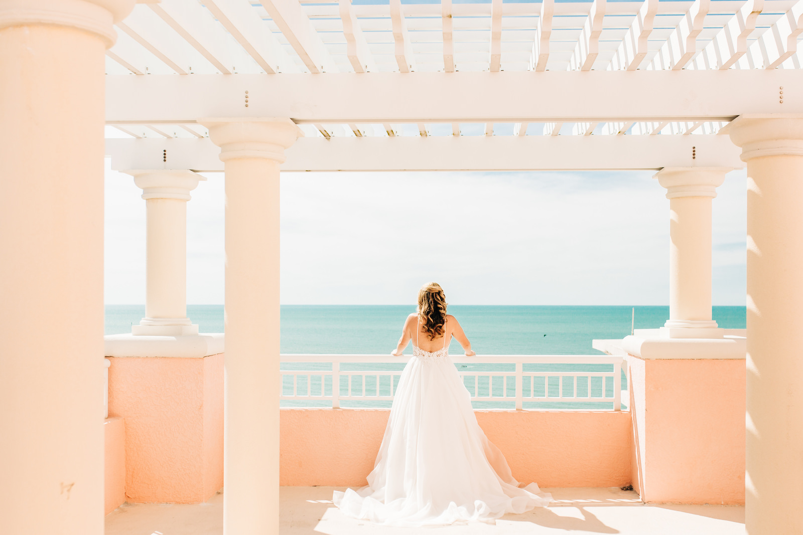 Tampa Bay Bride Overlooking Breathtaking Waterfront Ocean Scenery on Balcony of Wedding Venue Florida Destination Wedding Resort and Hotel Hyatt Regency Clearwater Beach
