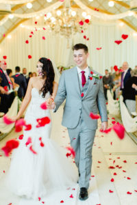 Bride and Groom Ceremony Exit with Red Rose Petal Toss | Groom Wearing Classic Silver Grey Suit with Burgundy Neck Tie