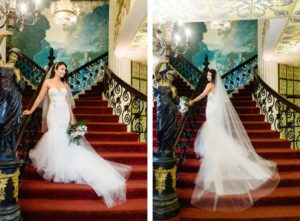 Indoor Bridal Portrait on Grand Staircase for Fairy Tale Disney Wedding | Mermaid Fitted Lace Sweetheart Wedding Gown with Tulle Skirt and Sheer Illusion Panels with Long Cathedral Veil from Tampa Dress Shop Isabel Oneil Bridal Collection
