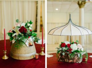 Clearwater Florida Disney Fairy Tale Wedding Reception Centerpiece Mary Poppins Bag and Umbrella with White Hydrangea and Red and Pink Roses | Lady and the Tramp Centerpiece with White Lily and Red and Pink Roses and Greenery on Barrel Table with Gold Candlesticks