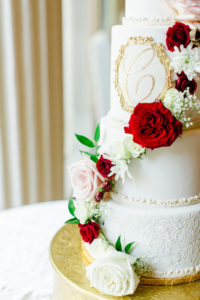 4 Tier Fondant Lace Wedding Cake with Gold Monogram and Cascade of Fresh Blush Pink and Red and White Roses with Babies Breath on Gold Ornate Round Cake Stand | Tampa Wedding Cake Bakery The Artistic Whisk