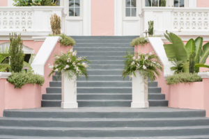 St. Petersburg Historic Wedding Venue The Pink Palace, Don Cesar Steps, White Pillars with Tropical Palm Leaves and Ivory Floral Arrangements | Tampa Bay Wedding Planner Elegant Affairs by Design | Styled Shoot