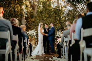 St. Pete Modern Bride and Groom Exchanging Wedding Vows During Ceremony with Tropical Backdrop | Boutique Hotel Venue Hotel Zamora