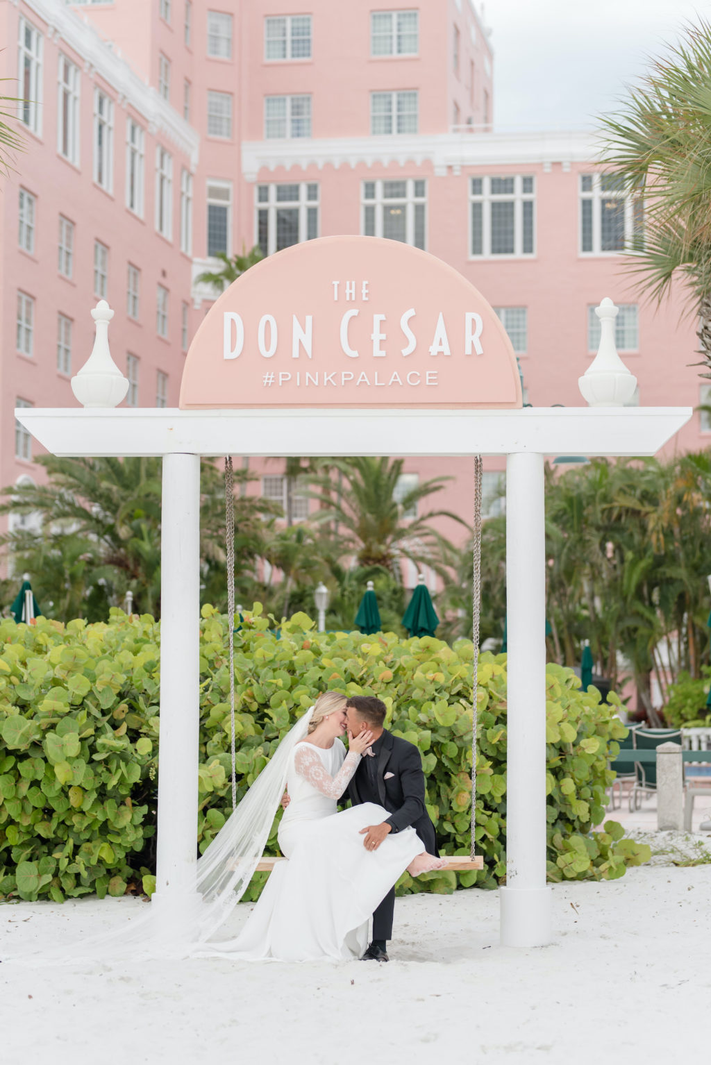 Romantic Bride and Groom on Swing on White Sand Beach of St. Petersburg Historic Wedding Venue The Pink Palace, Don Cesar | Styled Shoot