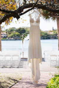 Romantic, Vintage Inspired Stella York Wedding Dress Hanging from Tree in Outdoor Ceremony Venue | St. Petersburg Women's Club | Florida Wedding Planner Special Moments Event Planning | Tampa Bay Wedding Photographer Grind & Press
