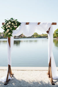 Florida Waterfront Wedding Ceremony, Lakeside Ceremony with Wooden Arch and White Draping, Modern Floral Arrangement with Blush Pink and Ivory Roses and Greenery | Cotton & Magnolia Boutique Wedding Florist | Tampa Bay Wedding Day of Coordinator Special Moments Event Planning | Florida Wedding Venue St. Petersburg Women's Club