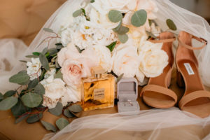 Tan Sandal Steve Madden Wedding Heel Shoes, Chanel Perfume Bottle, Engagement Ring in Velvet Ring Box, Bridal Bouquet with Ivory and Blush Pink Roses, White Flowers and Eucalyptus