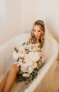 Creative and Unique Bridal Photo, Bride in Bathtub Wearing Full Length Veil Holding Romantic Lush White, Ivory and Blush Pink Roses, Eucalyptus Floral Bouquet