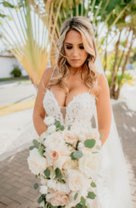 St. Pete Bride in Romantic Sweetheart V Neck Lace and Illusion Wedding Dress with Spaghetti Straps Holding Lush Blush Pink, White, Ivory and Eucalyptus Floral Bouquet, Full Length Veil