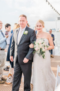 Bride Walking Down Aisle with Father during Outdoor Tampa Waterfront Wedding Ceremony | Blush Pink and Ivory Roses and Greenery and Baby's Breath Bridal Bouquet