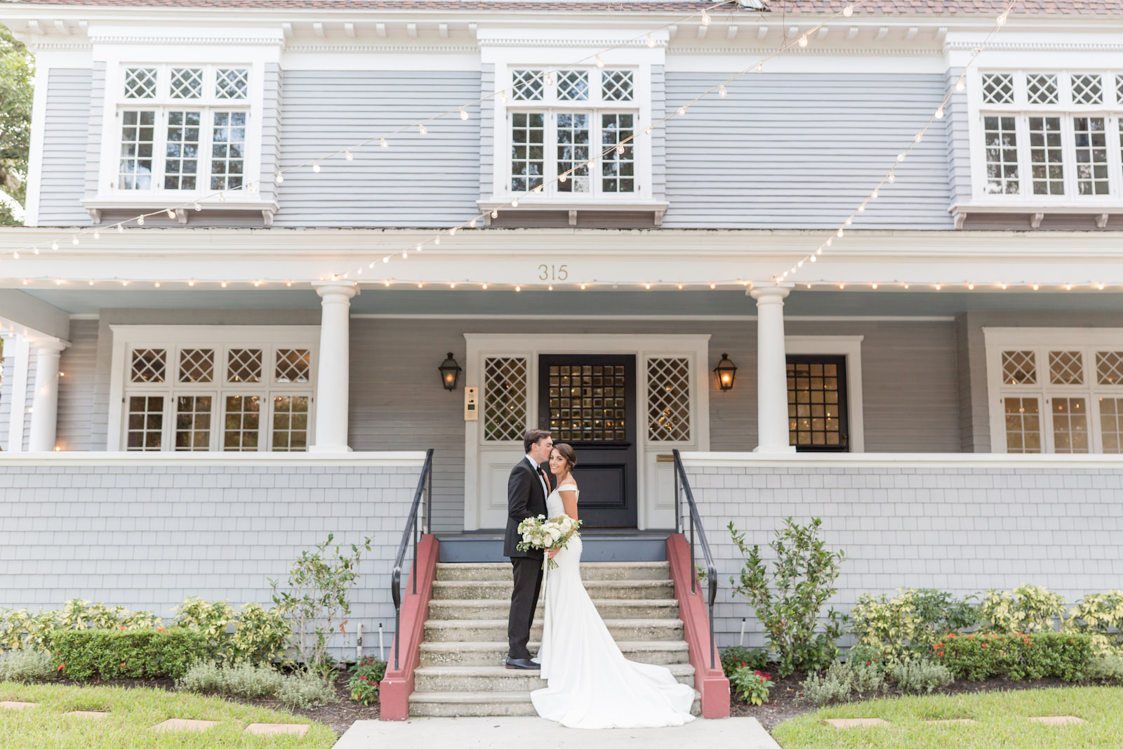Classic and timeless bride and groom on front steps of Tampa historic wedding venue The Orlo
