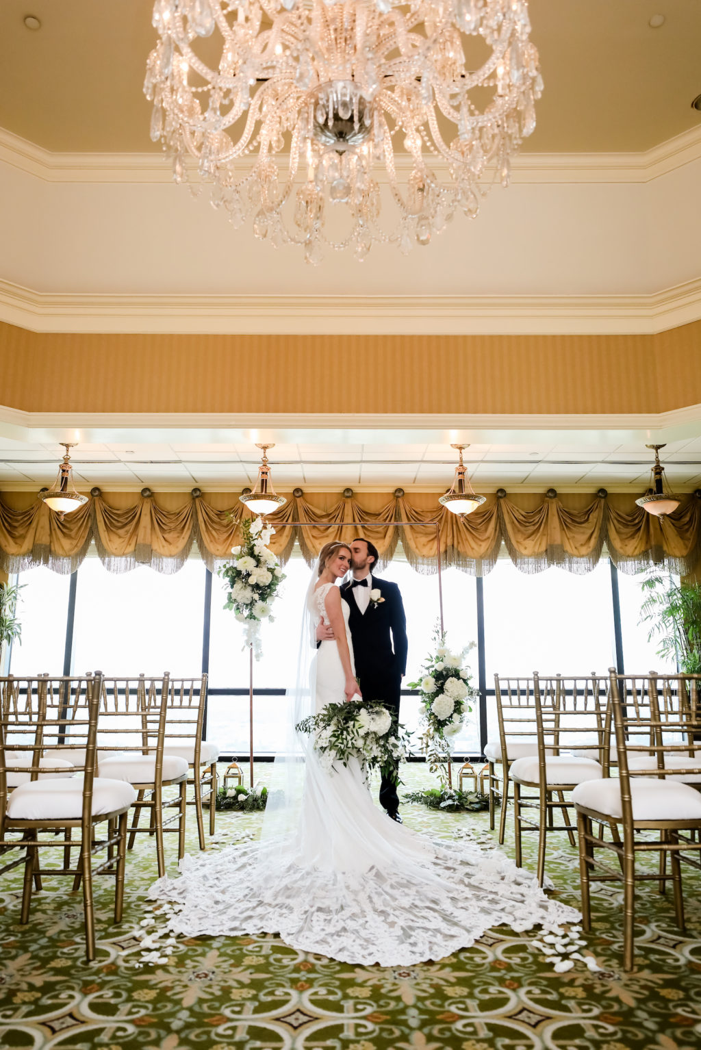 Classic Bride and Groom Exchanging Wedding Vows During Ceremony, Rectangular Arch with White and Greenery Lush Floral Arrangements, Gold Chiavari Chairs | Tampa Bay Wedding Planner Elegant Affairs by Design | Wedding Venue The Tampa Club | Wedding Photographer Lifelong Photography Studio | Wedding Rentals Outside the Box Event Rentals | Wedding Dress and Tuxedo Truly Forever Bridal | Styled Shoot