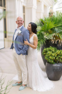 Clearwater bride in fitted lace wedding dress and groom in pale blue suit jacket and cream linen pants with blue shoes | Tampa Bay boutique bridal shop Isabel O'Neil