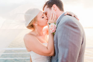 Bride and Groom Outdoor Sunset Portrait Veil Shot Kiss