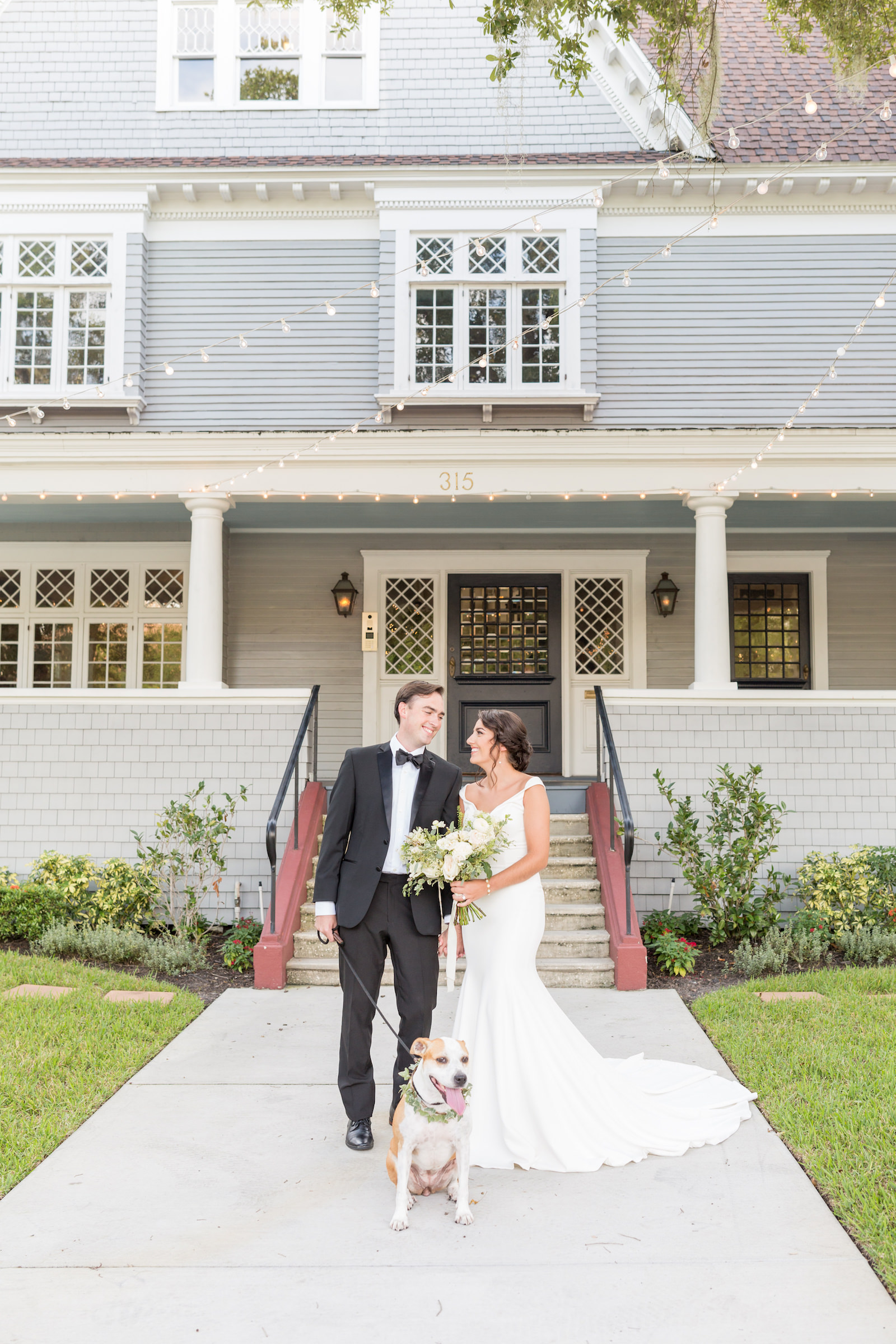 Classic and timeless bride and groom outside with dog, historic Tampa wedding venue The Orlo | Wedding pet planner FairyTail Pet Care