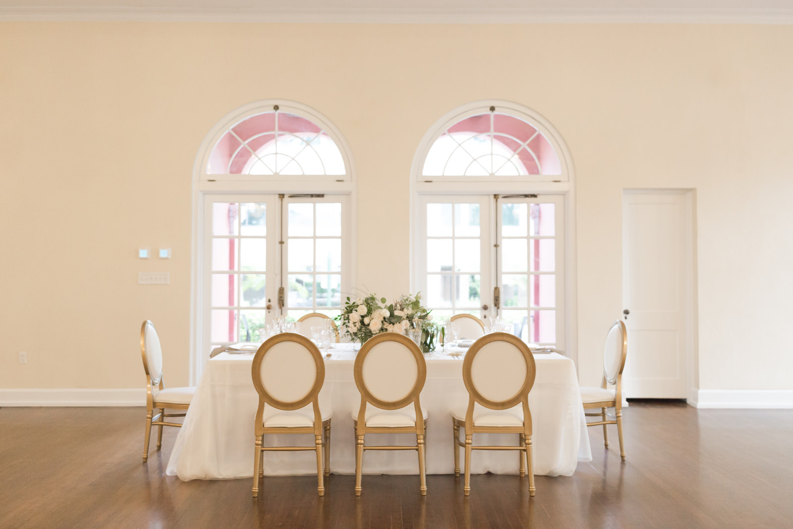 Southern Charm classic and traditional wedding reception decor, long table with white tablecloth, Louis XVI Chair and lush white floral centerpiece | Tampa Bay wedding planner and design Elegant Affairs by Design | Kate Ryan Event Rentals