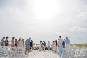 Clearwater Beach bride and groom exchanging wedding vows during ceremony on sand | Waterfront wedding venue Sandpearl Resort | Tampa wedding planner Parties A'la Carte