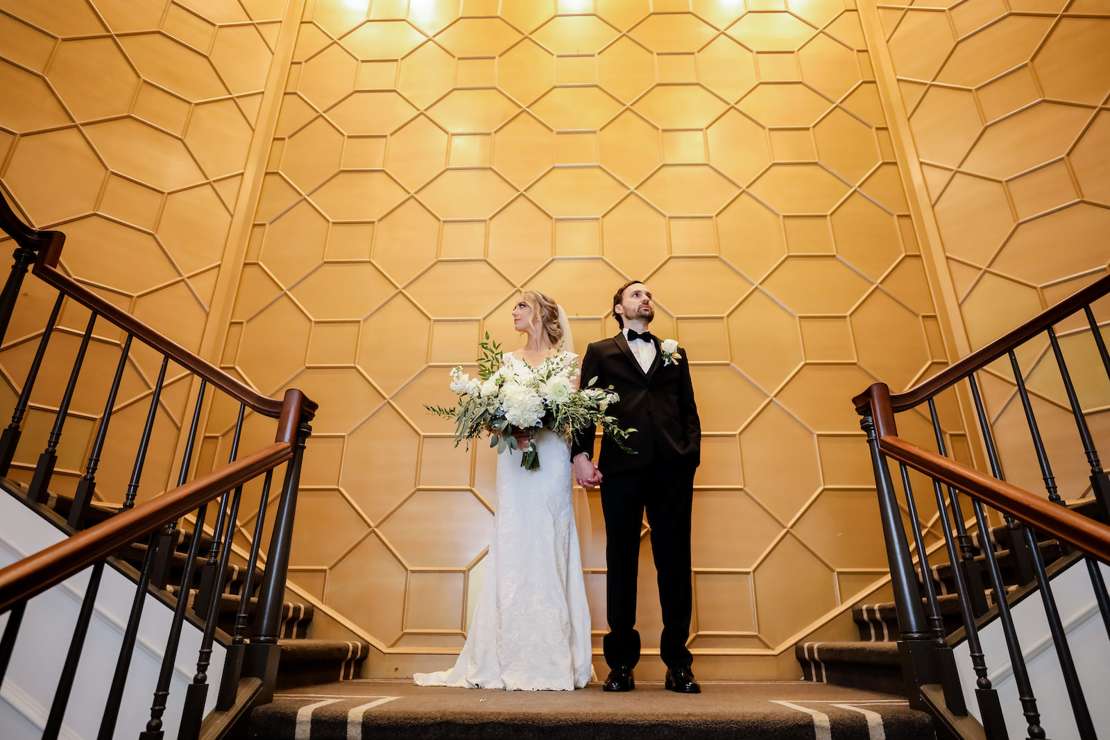 Classic bride in lace and illusion wedding dress with romantic train and full length veil holding lush white and greenery floral bouquet, groom in black tuxedo | Wedding Venue The Tampa Club | Wedding Dress and Tux Truly Forever Bridal | Wedding Photographer Lifelong Photography Studio | Styled Shoot | Wedding Hair and Makeup Femme Akoi Beauty Studio