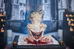Creepy Two Tier White Cake with Scary Mouth and Razor Sharp Teeth with Blood Splattered and Severed Hands Halloween Themed Wedding Cake, White Roses Cake and Knife Cake Topper, Wedding Dessert Table | Tampa Bay Cake Company The Artistic Whisk | Wedding Planner UNIQUE Weddings and Events
