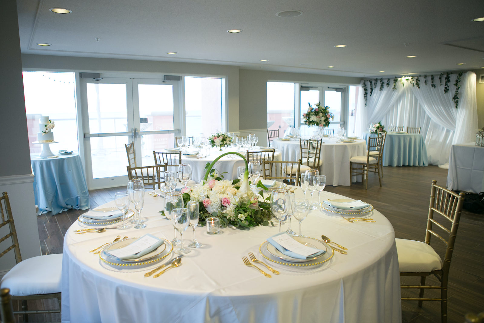 Elegant Modern Wedding Reception Decor, Round Tables with White Linens, Gold Chiavari Chairs, Greenery, White and Pink Floral Centerpiece, Gold Flatware, Gold Beaded and Clear Chargers | Tampa Bay Wedding Planner Coastal Coordinating | Wedding Venue Hyatt Regency Clearwater Beach | Wedding Florida Brides N Blooms | Wedding Rentals Outside the Box |