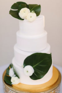 Four Tier White Wedding Cake with Tropical Palm Leaves and White Roses